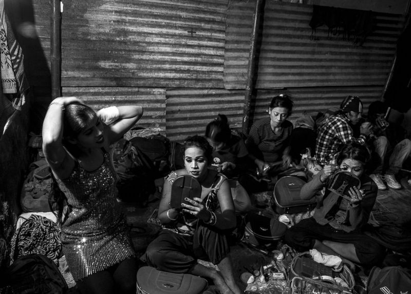 these-actors-prepare-in-a-small-make-up-room-made-of-curtains-behind-the-stage